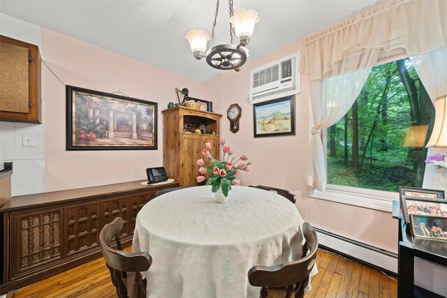 397 Mine Rd, Monroe, NY 10950 - dining area featuring baseboard heating, a chandelier, wood-type flooring, and healthy amount of natural light
