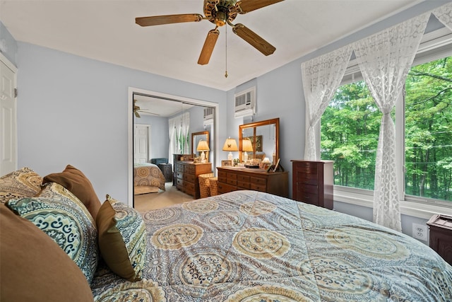 397 Mine Rd, Monroe, NY 10950 - carpeted bedroom with a closet, an AC wall unit, and a ceiling fan