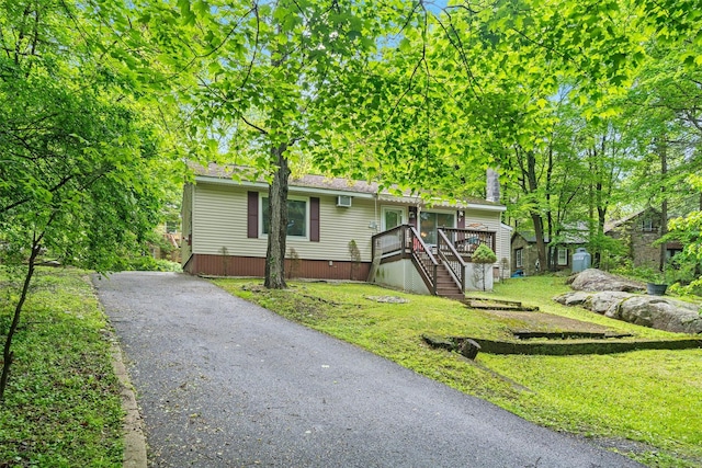 397 Mine Rd, Monroe, NY 10950 - view of front of home with stairway, a wooden deck, a front yard, and driveway