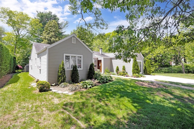 15 W Forest Ave, Freeport, NY 11520 - view of front facade with a front lawn and a shingled roof
