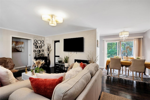 15 W Forest Ave, Freeport, NY 11520 - living room featuring dark wood-style flooring, crown molding, a chandelier, baseboards, and a fireplace