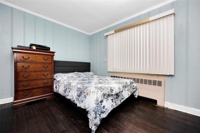 15 W Forest Ave, Freeport, NY 11520 - bedroom with radiator, crown molding, hardwood / wood-style floors, and a decorative wall