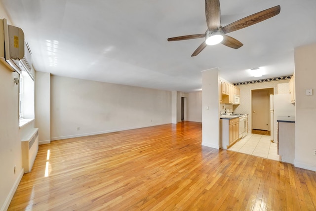 100 Lincoln Ave Unit 28C, Mineola, NY 11501 - unfurnished living room with light wood-type flooring, a ceiling fan, and baseboards