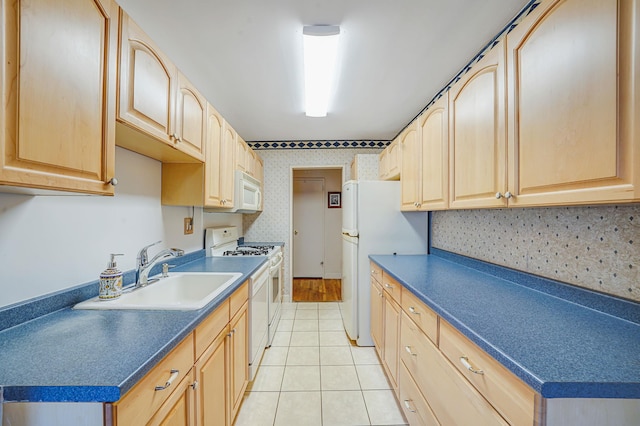 100 Lincoln Ave Unit 28C, Mineola, NY 11501 - kitchen with light brown cabinetry, a sink, white appliances, light tile patterned floors, and dark countertops