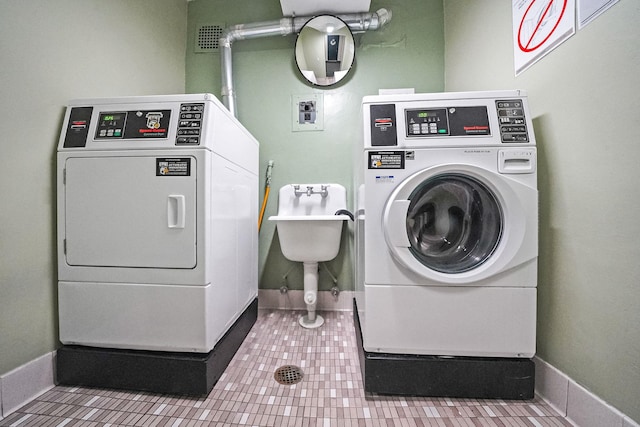 100 Lincoln Ave Unit 28C, Mineola, NY 11501 - communal laundry room with washing machine and dryer, tile patterned flooring, and baseboards