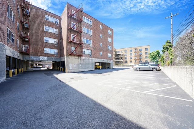 100 Lincoln Ave Unit 28C, Mineola, NY 11501 - view of apartment building / complex with uncovered parking