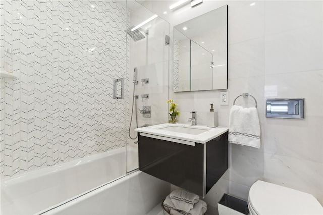 205 E 63rd St Phe, Phe New York Manhattan, NY 10065 - bathroom with tile walls, vanity, combined bath / shower with glass door, and toilet