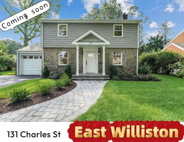 131 Charles St, East Williston, NY 11596 - colonial-style house featuring stone siding, a front lawn, a chimney, a garage, and asphalt driveway