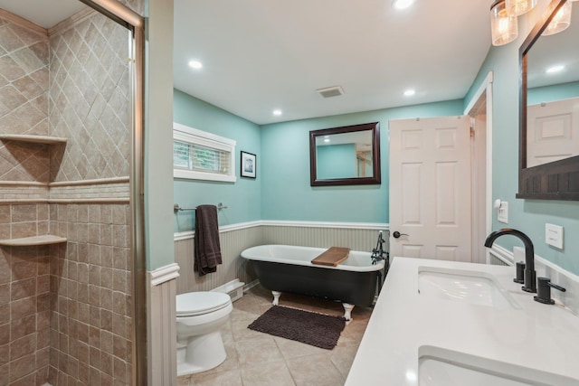 49 Brook Trl, Greenwood Lake, NY 10925 - bathroom featuring wainscoting, toilet, a freestanding tub, a stall shower, and tile patterned floors