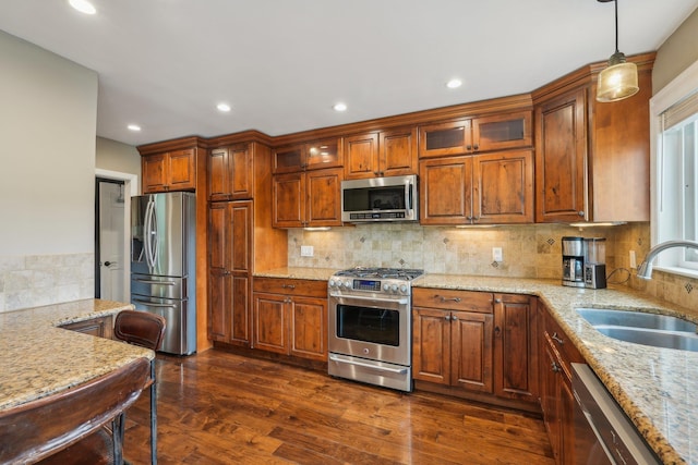 49 Brook Trl, Greenwood Lake, NY 10925 - kitchen featuring stainless steel appliances, a sink, light stone counters, decorative backsplash, and glass insert cabinets