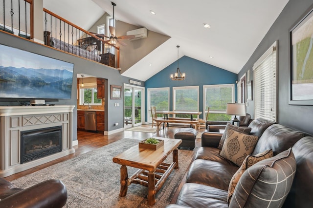 49 Brook Trl, Greenwood Lake, NY 10925 - living area with a chandelier, ceiling fan, wood finished floors, a wall mounted AC, and a glass covered fireplace
