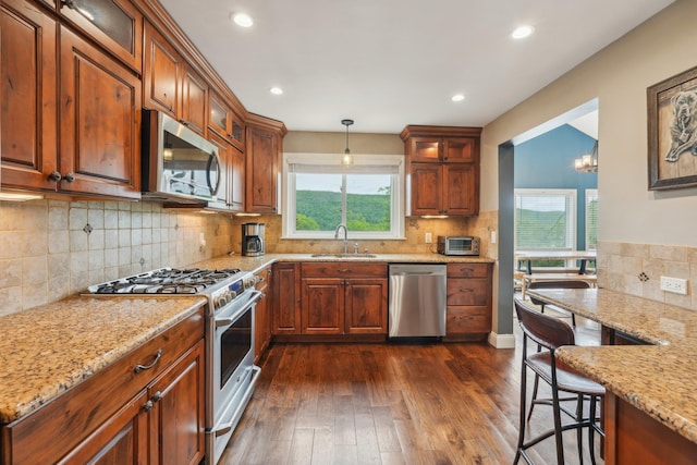 49 Brook Trl, Greenwood Lake, NY 10925 - kitchen with stainless steel appliances, a sink, glass insert cabinets, light stone counters, and tasteful backsplash