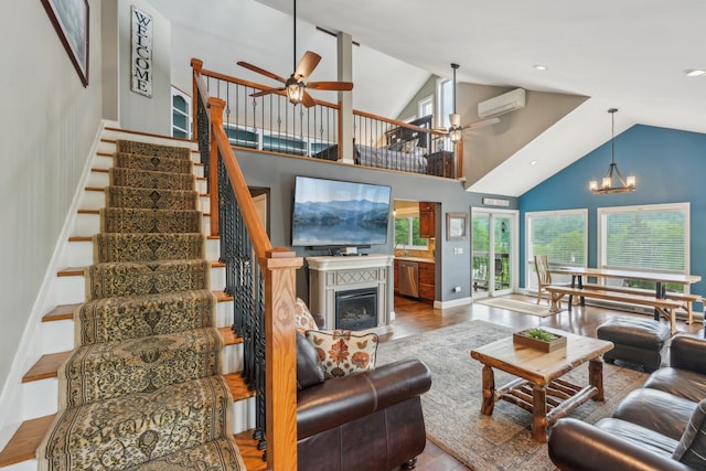 49 Brook Trl, Greenwood Lake, NY 10925 - living area featuring a ceiling fan, wood finished floors, stairs, a glass covered fireplace, and an AC wall unit