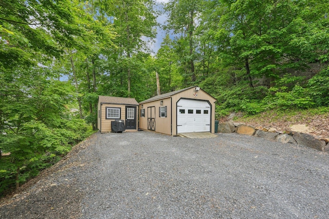 49 Brook Trl, Greenwood Lake, NY 10925 - view of front of home featuring an outbuilding, a detached garage, and gravel driveway