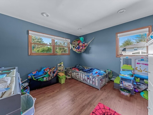 4 Whitebirch Ln, Commack, NY 11725 - bedroom with wood finished floors and a baseboard heating unit
