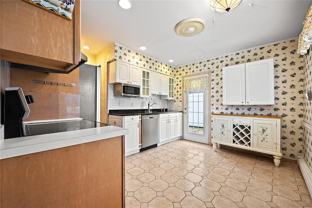 21 Arizona Ave, Syosset, NY 11791 - kitchen featuring stainless steel appliances, wallpapered walls, baseboard heating, white cabinetry, and glass insert cabinets