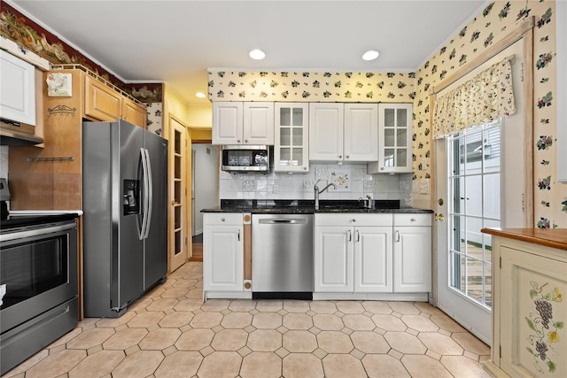21 Arizona Ave, Syosset, NY 11791 - kitchen featuring stainless steel appliances, plenty of natural light, glass insert cabinets, tasteful backsplash, and crown molding