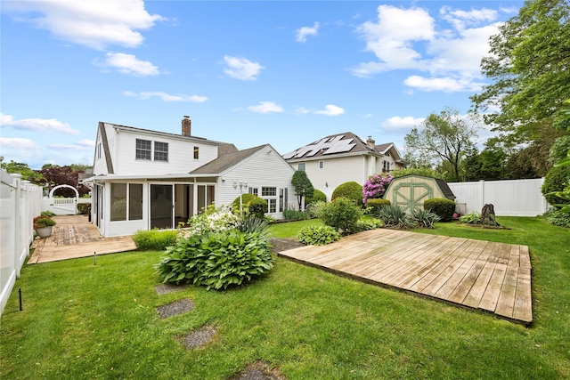 21 Arizona Ave, Syosset, NY 11791 - back of property featuring a sunroom, a wooden deck, and a chimney