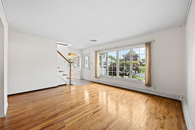 21 Arizona Ave, Syosset, NY 11791 - unfurnished living room with stairs, hardwood / wood-style floors, a baseboard heating unit, crown molding, and baseboards
