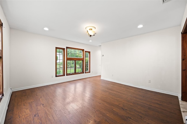 21 Arizona Ave, Syosset, NY 11791 - unfurnished room with wood finished floors, a baseboard heating unit, baseboards, and recessed lighting
