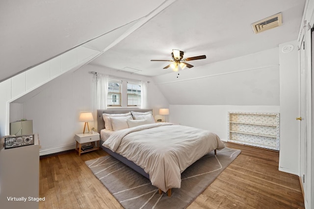 21 Arizona Ave, Syosset, NY 11791 - bedroom with wood-type flooring, vaulted ceiling, ceiling fan, and a baseboard radiator