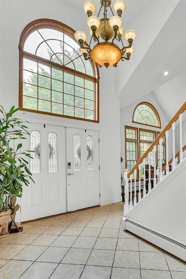 1138 Carlls Straight Path, Dix Hills, NY 11746 - tiled entrance foyer featuring a chandelier, high vaulted ceiling, a baseboard heating unit, and stairs