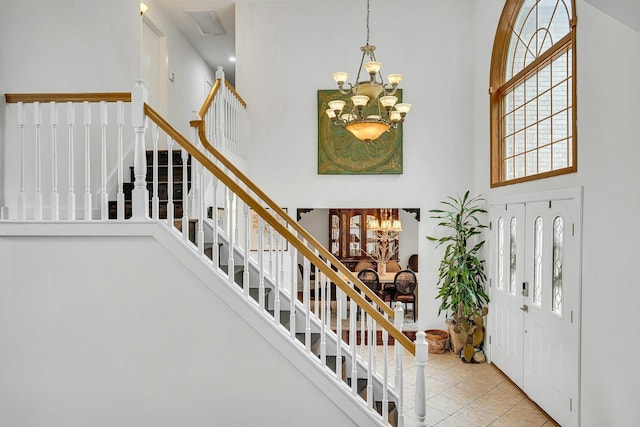 1138 Carlls Straight Path, Dix Hills, NY 11746 - foyer with a towering ceiling, a chandelier, stairs, and tile patterned flooring