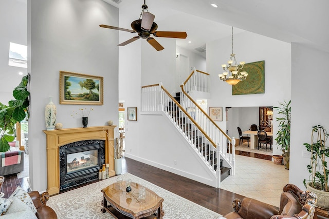 1138 Carlls Straight Path, Dix Hills, NY 11746 - living room with a high ceiling, stairway, a chandelier, wood finished floors, and a fireplace