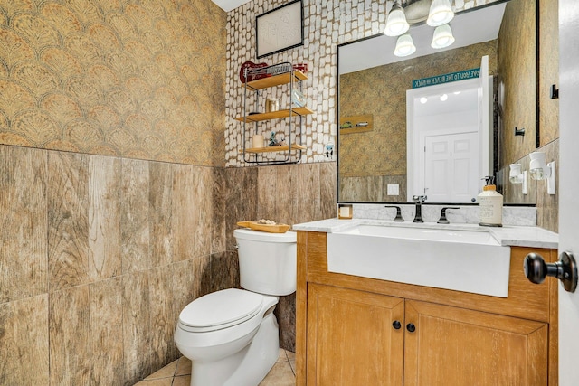 1138 Carlls Straight Path, Dix Hills, NY 11746 - bathroom featuring toilet, vanity, tile walls, tile patterned floors, and wainscoting