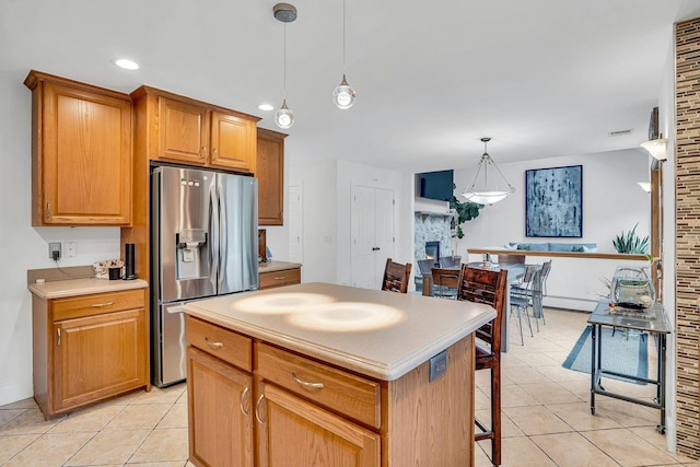 1138 Carlls Straight Path, Dix Hills, NY 11746 - kitchen with stainless steel fridge, light tile patterned flooring, hanging light fixtures, a kitchen island, and recessed lighting