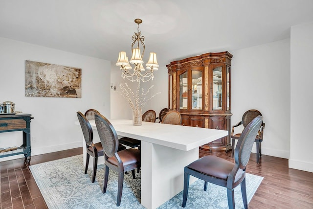 1138 Carlls Straight Path, Dix Hills, NY 11746 - dining space featuring a chandelier, dark wood-type flooring, and baseboards