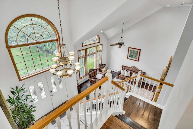 1138 Carlls Straight Path, Dix Hills, NY 11746 - staircase featuring high vaulted ceiling, a chandelier, wood finished floors, plenty of natural light, and recessed lighting