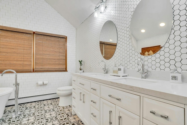 1138 Carlls Straight Path, Dix Hills, NY 11746 - full bathroom featuring tile walls, a baseboard heating unit, double vanity, tile patterned floors, and lofted ceiling