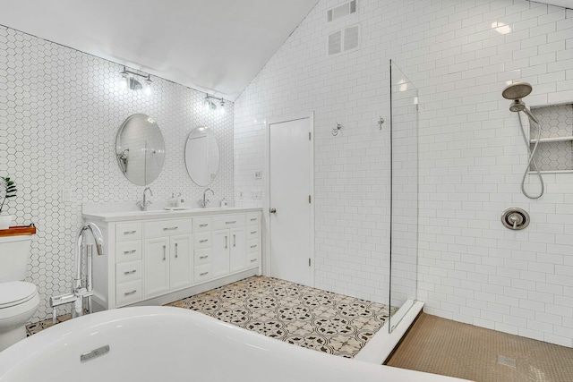 1138 Carlls Straight Path, Dix Hills, NY 11746 - full bathroom with vaulted ceiling, toilet, a tile shower, double vanity, and tile walls