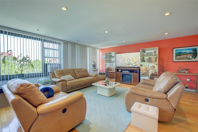 10-11 162nd St Unit 7A, Beechhurst, NY 11357 - living area with a glass covered fireplace, light wood-style floors, and recessed lighting