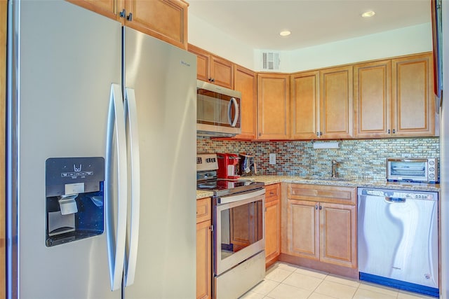 10-11 162nd St Unit 7A, Beechhurst, NY 11357 - kitchen with appliances with stainless steel finishes, a sink, light stone counters, decorative backsplash, and light tile patterned flooring