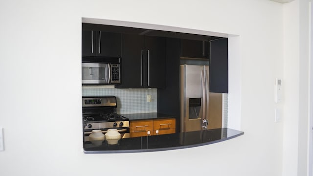 355 Kings Hwy Unit 5C, Brooklyn, NY 11223 - kitchen with stainless steel appliances, dark cabinets, backsplash, and dark countertops