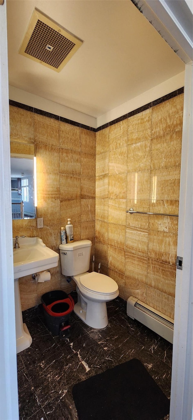 355 Kings Hwy Unit 5C, Brooklyn, NY 11223 - bathroom featuring marble tiled flooring, a baseboard heating unit, toilet, and a sink