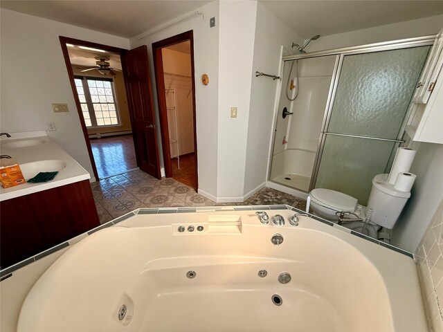 118 White Brg, Middletown, NY 10940 - bathroom featuring a stall shower, ceiling fan, a baseboard radiator, toilet, and double vanity