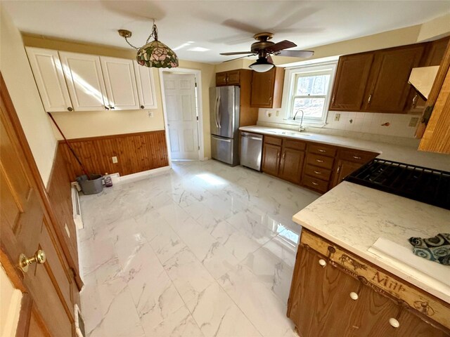 118 White Brg, Middletown, NY 10940 - kitchen with appliances with stainless steel finishes, a sink, wood walls, ceiling fan, and light marble finish floors