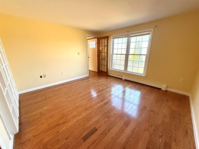 118 White Brg, Middletown, NY 10940 - spare room featuring a baseboard radiator, wood finished floors, and baseboards