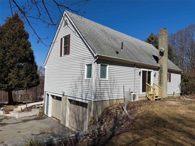 118 White Brg, Middletown, NY 10940 - view of property exterior with an attached garage, asphalt driveway, a chimney, and a shingled roof