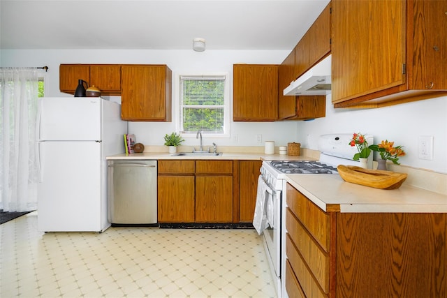 252 Rokeby Rd, Red Hook, NY 12571 - kitchen with white appliances, under cabinet range hood, a sink, light countertops, and brown cabinets