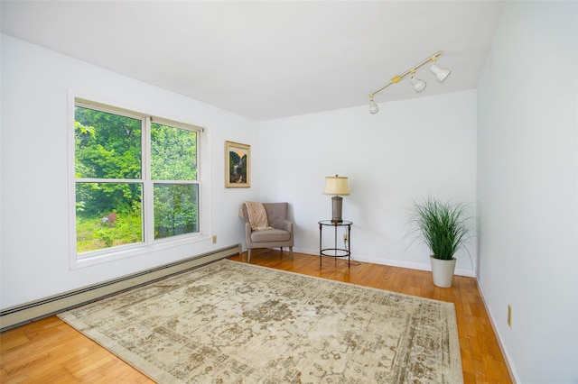 252 Rokeby Rd, Red Hook, NY 12571 - sitting room featuring plenty of natural light, track lighting, wood finished floors, and a baseboard radiator