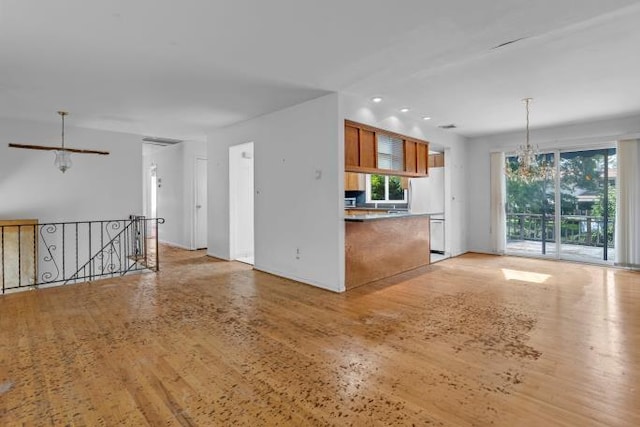 10 Lisa Dr, Northport, NY 11768 - kitchen featuring brown cabinetry, light wood-style floors, hanging light fixtures, recessed lighting, and glass insert cabinets