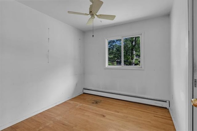 10 Lisa Dr, Northport, NY 11768 - empty room with a baseboard radiator, wood finished floors, and a ceiling fan