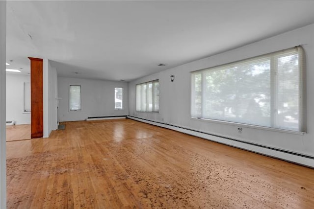 10 Lisa Dr, Northport, NY 11768 - unfurnished room featuring wood finished floors, baseboard heating, and a baseboard radiator