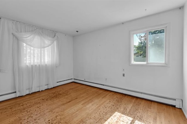 10 Lisa Dr, Northport, NY 11768 - spare room featuring a baseboard heating unit, wood finished floors, and baseboard heating