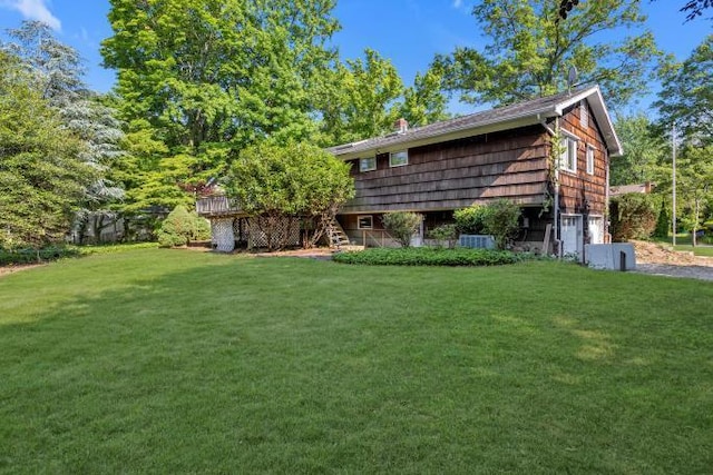 10 Lisa Dr, Northport, NY 11768 - view of green lawn featuring an attached garage and stairs