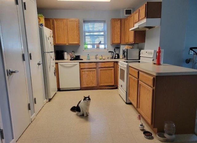 7914 Rockaway Beach Blvd Unit 1J, Rockaway Beach, NY 11693 - kitchen featuring white appliances, under cabinet range hood, light flooring, light countertops, and a sink